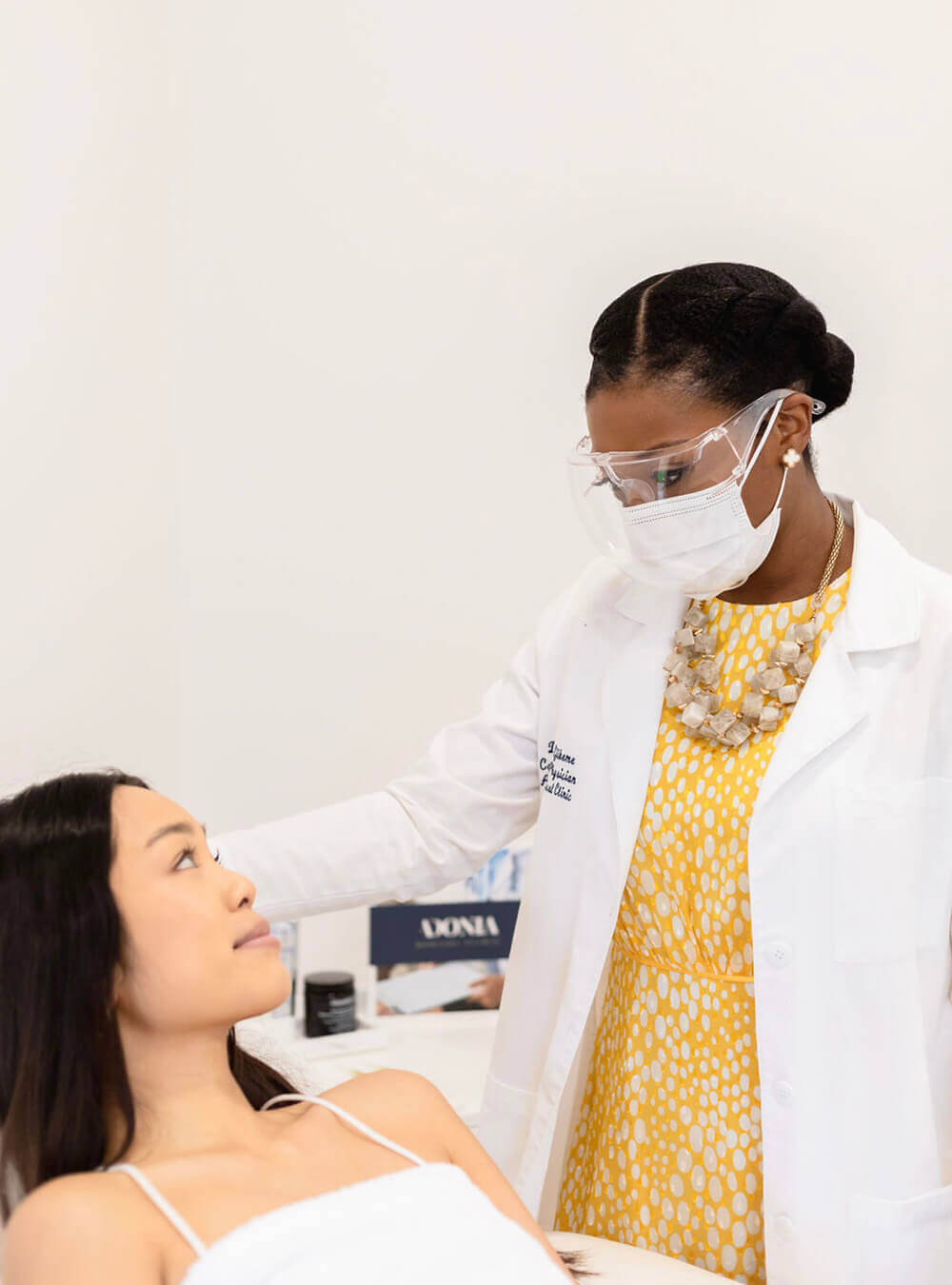 Dr Ifeoma Ejikeme discus with female patient about Facials treatment