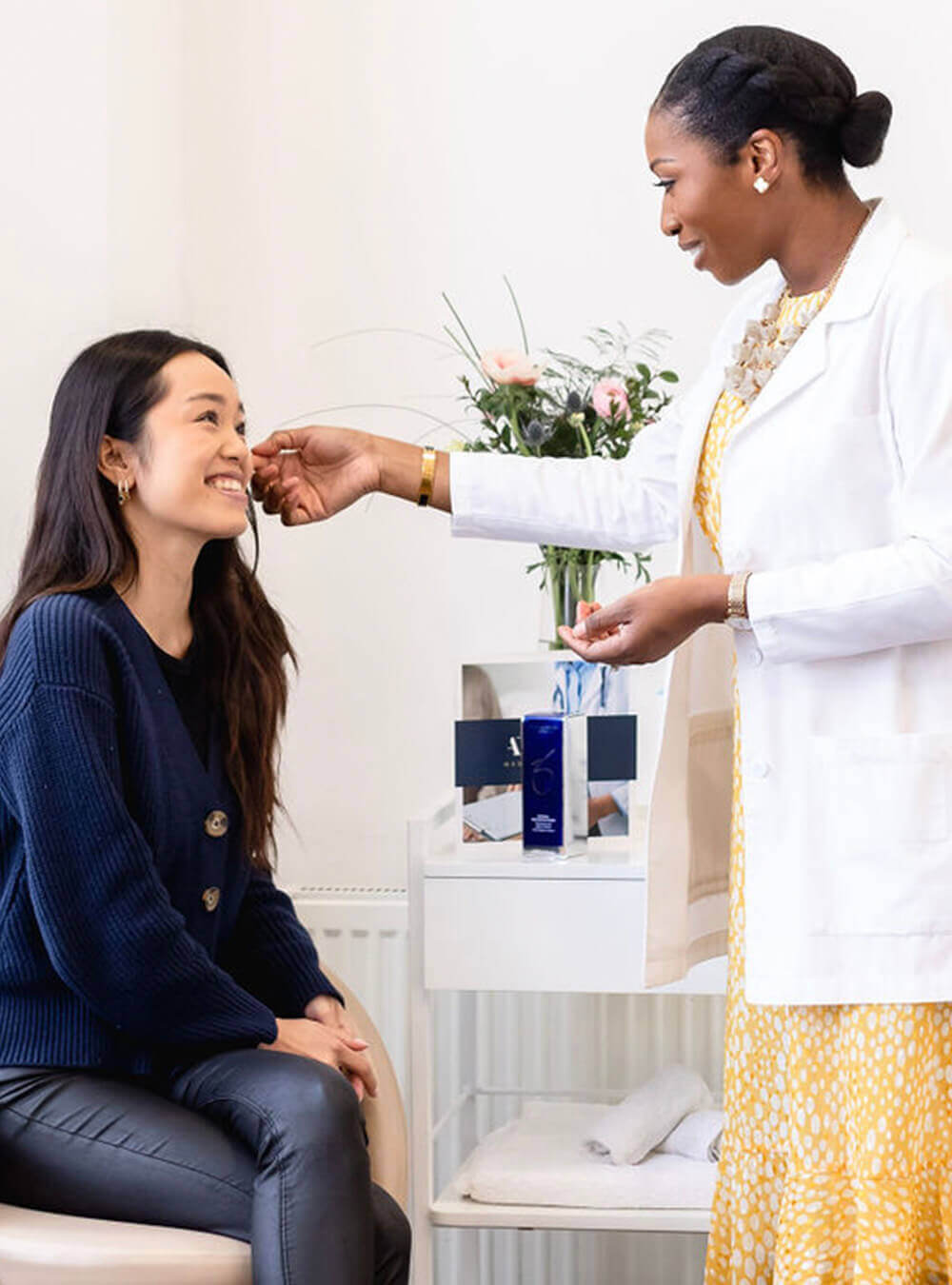 Dr Ifeoma Ejikeme discus with female patient about Hair Loss Treatments