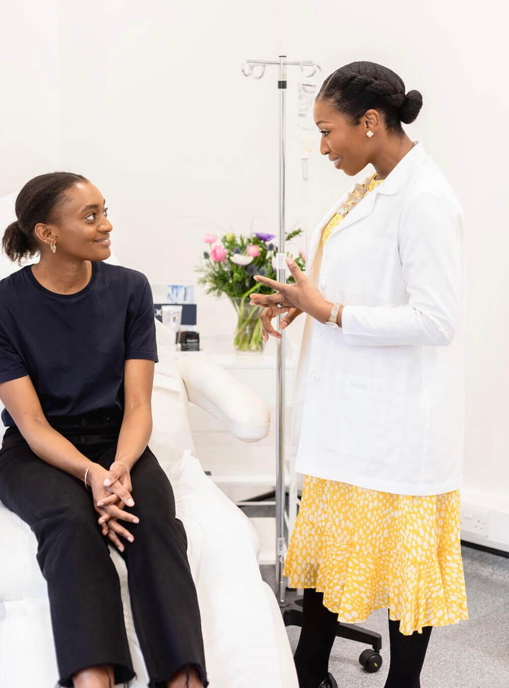 Dr Ifeoma Ejikeme discus with female patient about IV Infusions Treatment