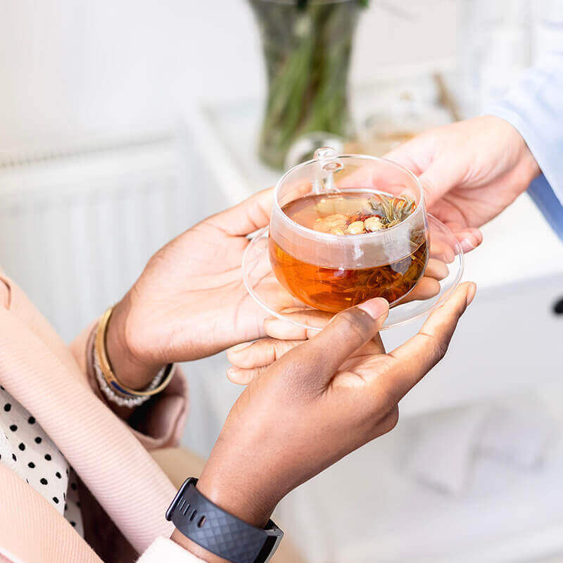 Book Your Treatment Today! - female patient with cup of tea